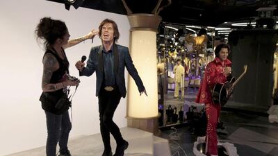 Hairdresser Virginie Dahan puts the final touches to Rolling Stones lead singer Mick Jagger’s statue. David W Cerny / Reuters