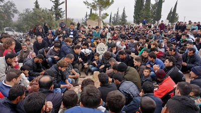 Mourners attend the funeral of Raed Fares and Hammud Al Junayd in Kafranbel, Idlib. AFP