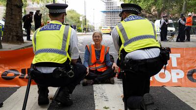 A 'Just Stop Oil' protester blocks a road leading into Westminster, London, on Wednesday. Reuters