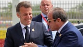 French President Emmanuel Macron, left, shakes hands with Egyptian President Abdel Fattah El Sisi at Senghor University in Borg El Arab, near Alexandria. AFP