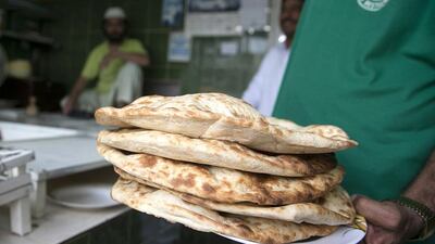 Freshly baked flat bread from the Ghazi bakery in central Abu Dhabi, made with subsidised flour. Silvia Razgova / The National