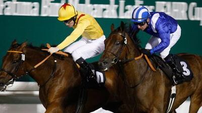 Almiqdaad, ridden by Tadhg O’Shea, right, edges out Radegund Abbey in the featured handicap race in Abu Dhabi last night.