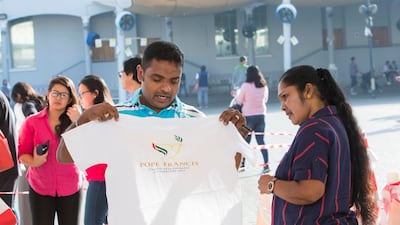 People try out their papal souvenirs.