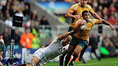 Will Genia of Australia is hauled down by Tom Croft of England at Twickenham yesterday.