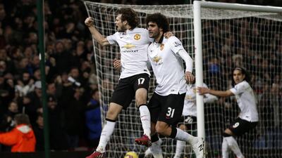 Manchester United midfielder Daley Blind, left, celebrates scoring his goal with Marouane Fellainiat Upton Park, in east London, on February 8, 2015. Adrian Dennis / AFP