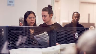 Staff scan ballots for the US midterm elections at the Maricopa County Tabulation and Election Centre in Phoenix, Arizona. Reuters