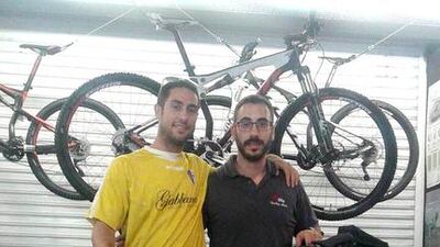 Abu Dhabi-based fitness instructor Eloy Maza, left, with his mechanic. Courtesy Eloy Maza