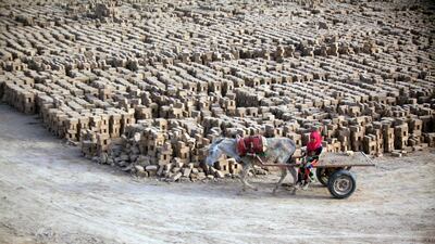 A girl steers a cart at a brick factory near Najaf, central Iraq. Haidar Hamdani / AFP Photo