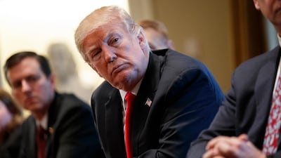 President Donald Trump listens during a meeting with steel and aluminum executives in the Cabinet Room of the White House. Evan Vucci / AP