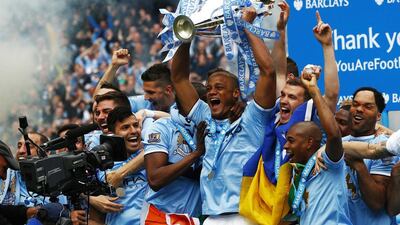 Manchester City captain Vincent Kompany celebrates with the Premier League trophy following their win over West Ham United at the Etihad Stadium on Sunday. Darren Staples / Reuters