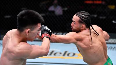 Kyler Phillips punches Song Yadong of China in their bantamweight fight during UFC 259 in Las Vegas, Nevada. USA TODAY Sports