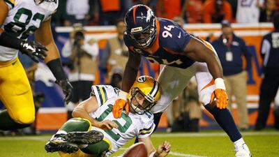 Denver Broncos outside linebacker DeMarcus Ware, top, sacks Green Bay Packers quarterback Aaron Rodgers for a fumble that led to a safety during the second half of an NFL football game, Sunday, Nov. 1, 2015, in Denver. (AP Photo/Jack Dempsey)