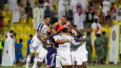 Sulaiman is swamped by his teammates after his shootout heroics against Al Jazira. Mike Young / The National