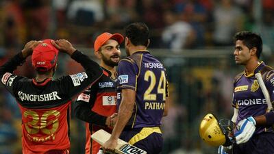 Kolkata Knight Riders batsman Yusuf Pathan (2nd R) is congratulated by Royal Challengers of Bangalore captain Virat Kohli (2nd L) after the team’s victory in the 2016 Indian Premier League (IPL) Twenty20 cricket match between Royal Challengers Bangalore and Kolkata Knight Riders, at The M Chinnaswamy Stadium in Bangalore on May 2, 2016. AFP / MANJUNATH KIRAN