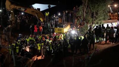Rescue workers carry the body of child 5-year-old Rayan Awram, who had been trapped for five days in a well, to an ambulance, near Chefchaouen, northern Morocco February 5, 2022, in this screen grab taken from a video. Reuters