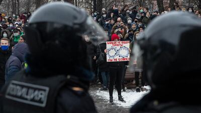 A woman holds a banner with portraits of Russian President Vladimir Putin and reads "We're not gonna take it anymore! We are not afraid", during a protest against the jailing of opposition leader Alexei Navalny in Moscow. AP Photo