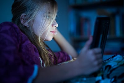 Traditional pastimes such as reading are being pushed aside as children spend hours glued to their phones checking their social media accounts. Getty