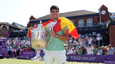 Carlos Alcaraz of Spain poses with the winner's trophy after victory against Alex De Minaur of Australia in the men's singles final at Queen's Club on June 25, 2023 in London, England. Getty Images