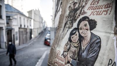 WWII propaganda poster read 'No more bad days, Dad earns money in Germany' on a deserted street transformed into a movie set, in Paris, France. EPA