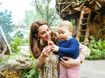 The Duchess of Cambridge and her son Prince Louis play in the garden before the RHS Chelsea Flower Show. AP