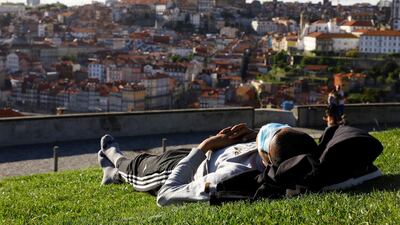 A man enjoys the sunny weather on the first day that tourists from Britain and most EU countries are allowed to enter Portugal without needing to quarantine, in Vila Nova de Gaia, Portugal. Reuters