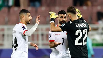 Palestine's Rami Hamada, Musab Battat and Samer Zubaida celebrate after securing a vital win in the group. Reuters