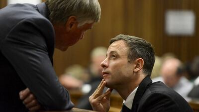 Oscar Pistorius, right, speaks with defence lawyer Brian Webber after his arrival in court in Pretoria, South Africa for his sentencing on Tuesday, October 21, 2014. Judge Thokozile Masipais handed a five-year sentence to Pistorius for culpable homicide in the killing of his girlfriend Reeva Steenkamp. Herman Verwey/AP Photo