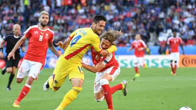 Florin Andone (C) of Romania in action against Michael Lang (R) of Switzerland during the UEFA EURO 2016 group A preliminary round match between Romania and Switzerland at Parc de Princes in Paris, France, 15 June 2016. EPA/FILIP SINGER