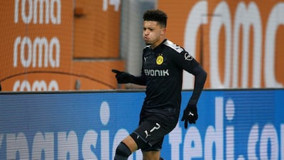 Jadon Sancho celebrates scoring Borussia Dortmund's third goal against Augsburg. Reuters