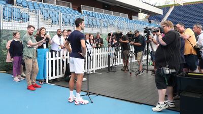 Novak Djokovic talks to the media after a practice session at Memorial Drive. Getty
