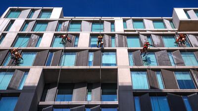 Window cleaners at work at NYU Abu Dhabi. Victor Besa / The National