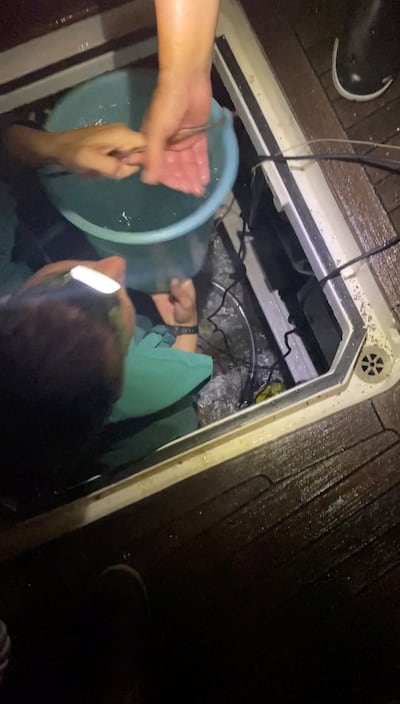 Crew members bail water from the Mustique after it was damaged by killer whales off the coast of southern Spain. Reuters