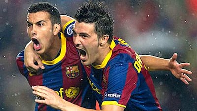 Pedro, left, celebrates scoring the opening goal with Barca teammate David Villa at Camp Nou.