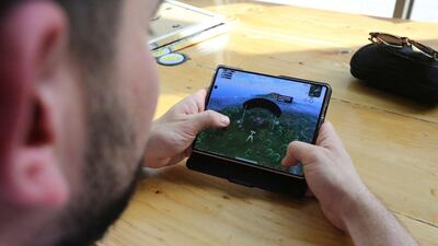 Mr Jaafar demonstrates on a mobile device the Battlegrounds game that has transfixed Iraq's youth. AFP