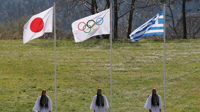 The flag of Japan, the Olympic flag and the flag of Greece during the ceremony. Reuters
