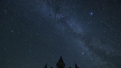 A meteor from the Perseids meteor shower burns up in the atmosphere behind a Catholic church near the village of Bogushevichi, Belarus. EPA