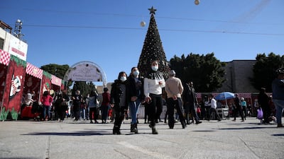 Palestinians visit the Christmas market at the Manger Square, next to the Church of Nativity, in the West Bank city of Bethlehem. EPA