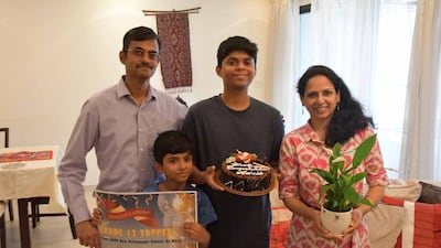 Advik Unni, pictured with his family, received gifts from his school on exam results day. Photo: Gems Education