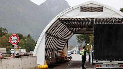 A German police officer checks a car at a border crossing point between Germany and Austria in Walserberg, Germany. EPA