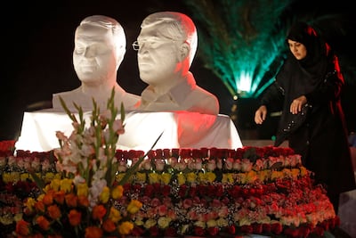 A woman lays flowers at the site where Qassem Suleimani and Abu Mahdi Al Muhandis were killed. AFP