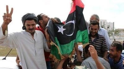 Libyan pro-government supporters celebrate in the streets of Bani Walid after seizing control of the city. Hundreds of fighters from Misrata converged on the centre of town, firing in the air and hoisting the Libyan flag to celebrate.