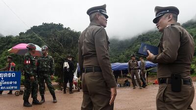 Police and soldiers guard a road leading to the Tham Luang cave area. AFP