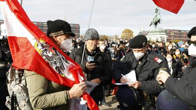 Police officers check the identity of demonstrators during a rally held by Austria's far-right Freedom Party FPOe. AFP