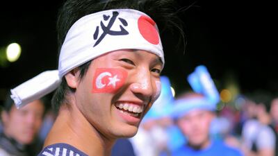 A Japanese tourist hanging out at Sultan Ahmed Square, in the Turkish capital of Istanbul, watches as the International Olympic Committee (IOC) gets ready to vote for which city should host the 2020 summer games - Madrid, Istanbul or Tokyo. AP Photo