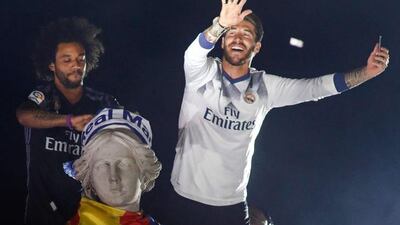 Real Madrid defender Sergio Ramos, right, and Marcelo celebrate the team’s win on Plaza Cibeles. Oscar del Pozo / AFP