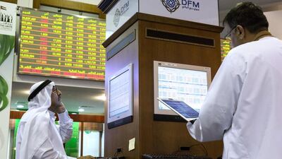 Above, traders at the Dubai Financial Market. Over the past three months, the Dubai index has fallen by 13 per cent. Duncan Chard for The National