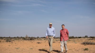 Dominique Burgeon, center, Director of the Emergency and Resilience Division of the Food and Agriculture Organization and Keith Cressman, right, Senior Locust Forecasting Officer, walk in the desert in the semi-autonomous Puntland region of Somalia. AP