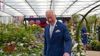 The king visits the Raymond Evison Clematis stand at the event. Getty