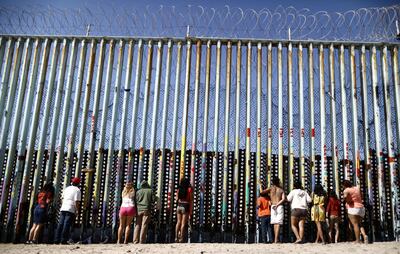 People look towards the US on the border barrier, on the US-Mexico border on the beach, on March 30, 2019 in Tijuana, Mexico. Getty Images