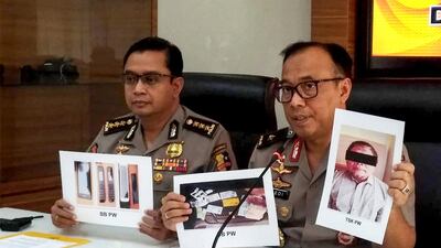 Indonesian police show photographs of leader Para Wijayanto following his arrest in Jakarta on July 1, 2019. AFP